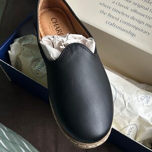 CHARIX Black Slip-On Shoes on Blue Display